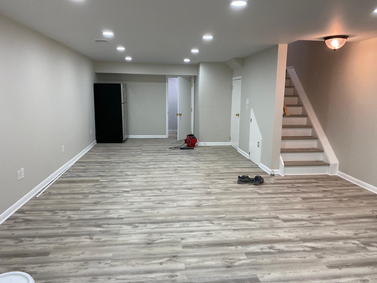 Finished basement with new flooring and staircase by Rome Leite Home Improvement