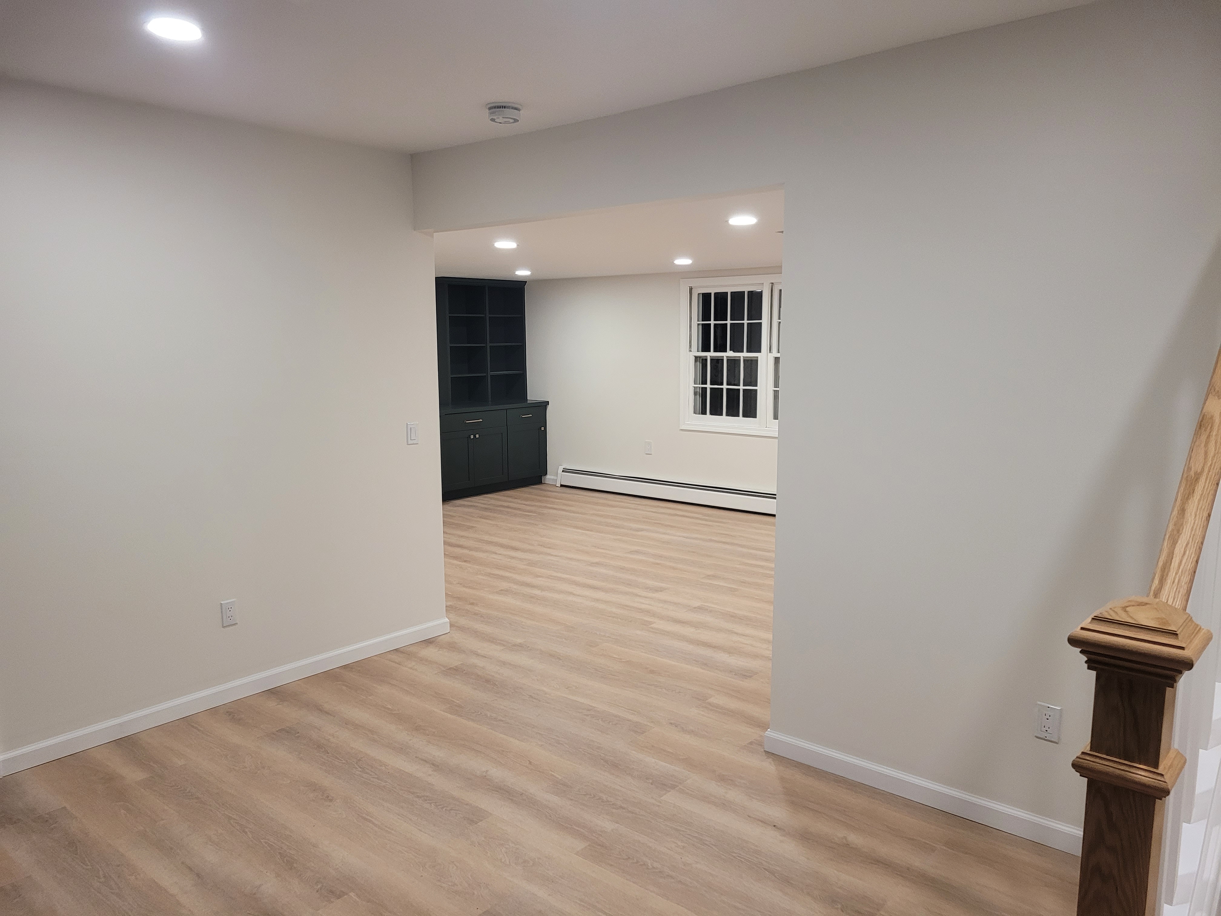 Finished basement with the staircase and French doors by Rome Leite Home Improvement in Danbury, CT