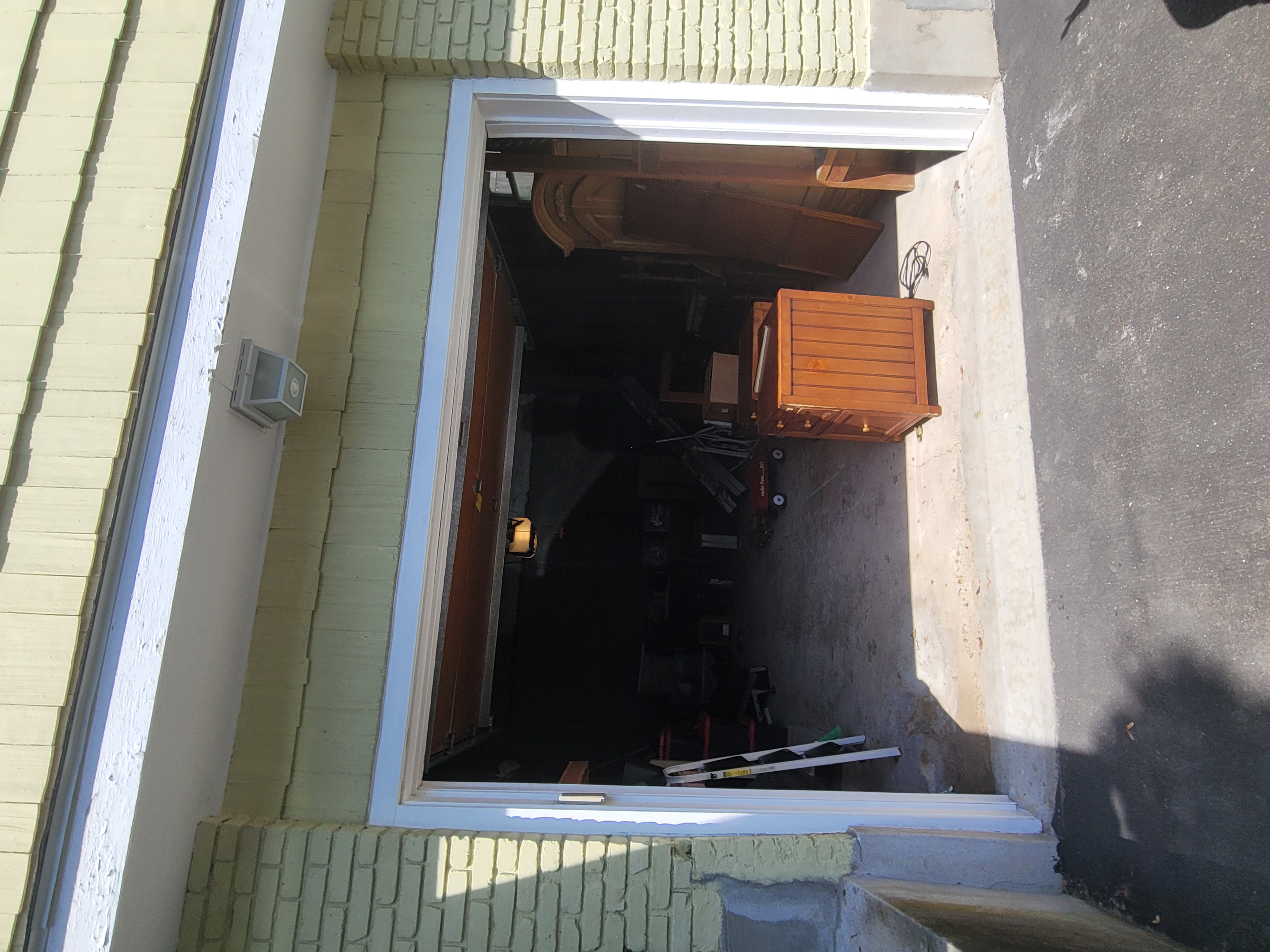 Overhead view through a newly cut basement egress window well by Rome Leite Home Improvement in Danbury, CT