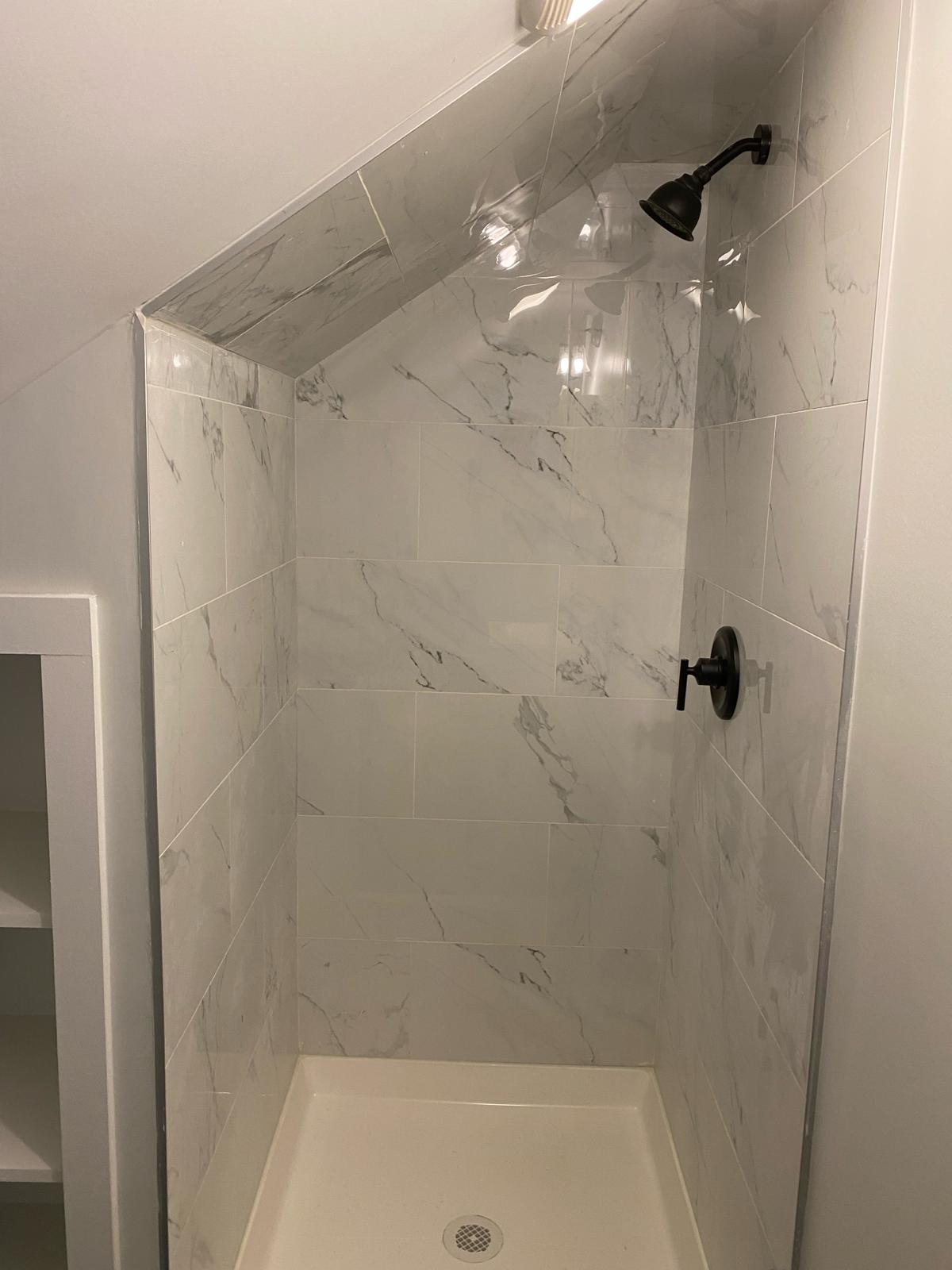 Finished marble tile shower remodel by Rome Leite Home Improvement in Danbury, CT