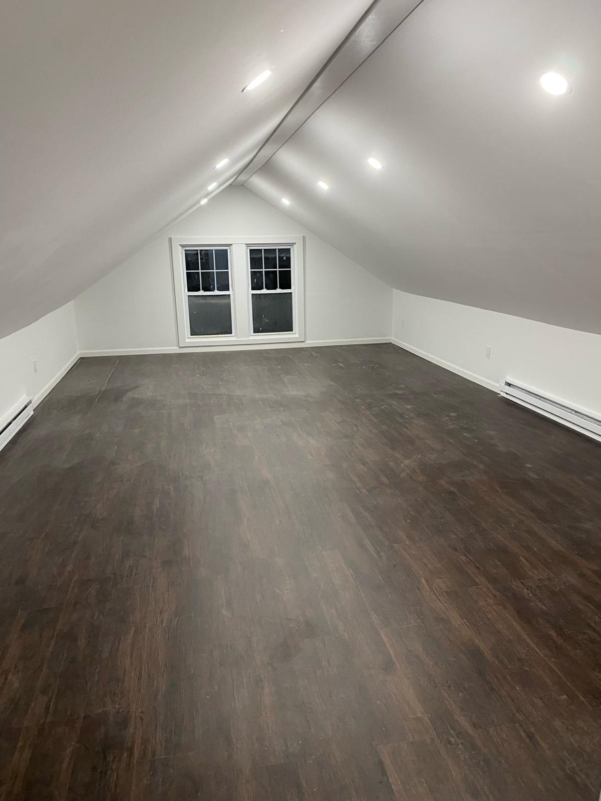 Finished attic conversion with vaulted ceiling by Rome Leite Home Improvement in Danbury, CT