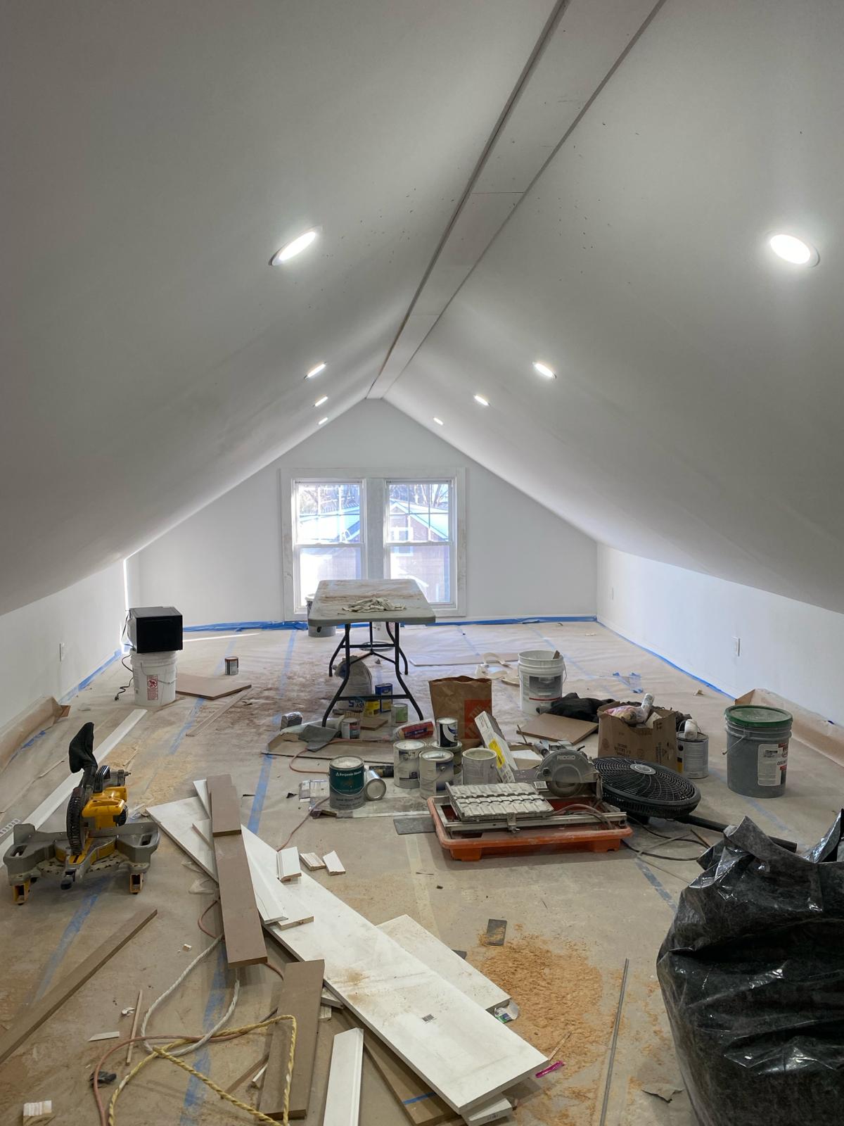 Finished vaulted attic ceiling with a smoke detector and two windows by Rome Leite Home Improvement in Danbury, CT
