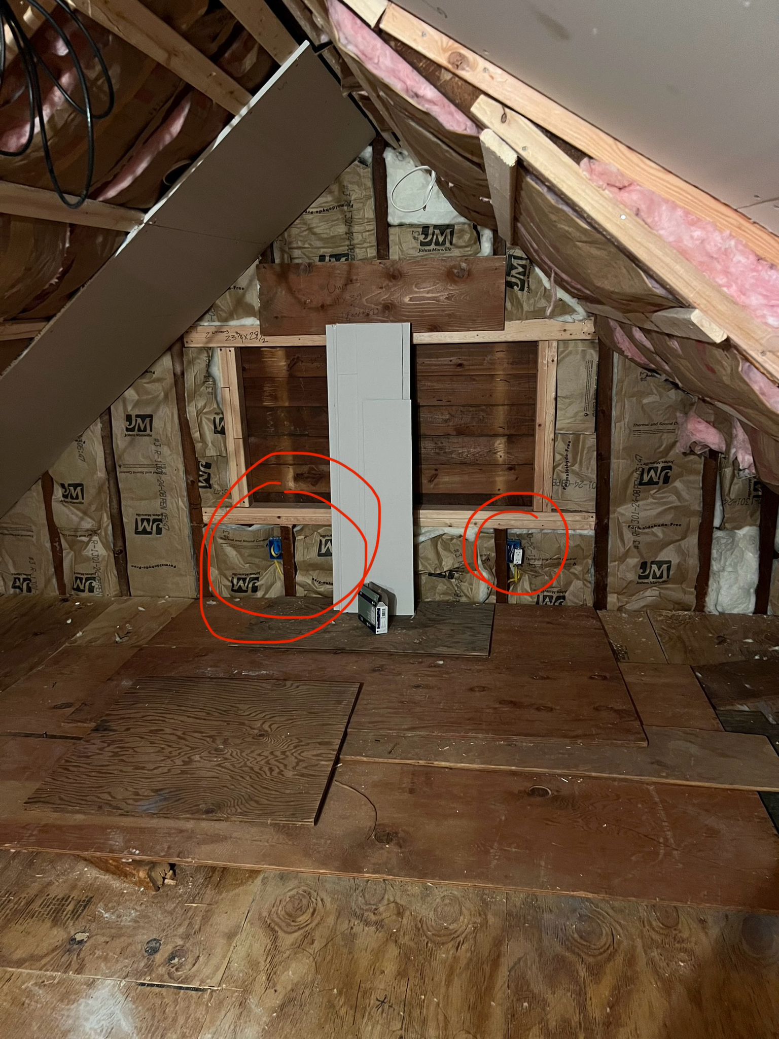 Unfinished attic knee-wall framing with insulation, marked with outlet locations by Rome Leite Home Improvement in Danbury, CT