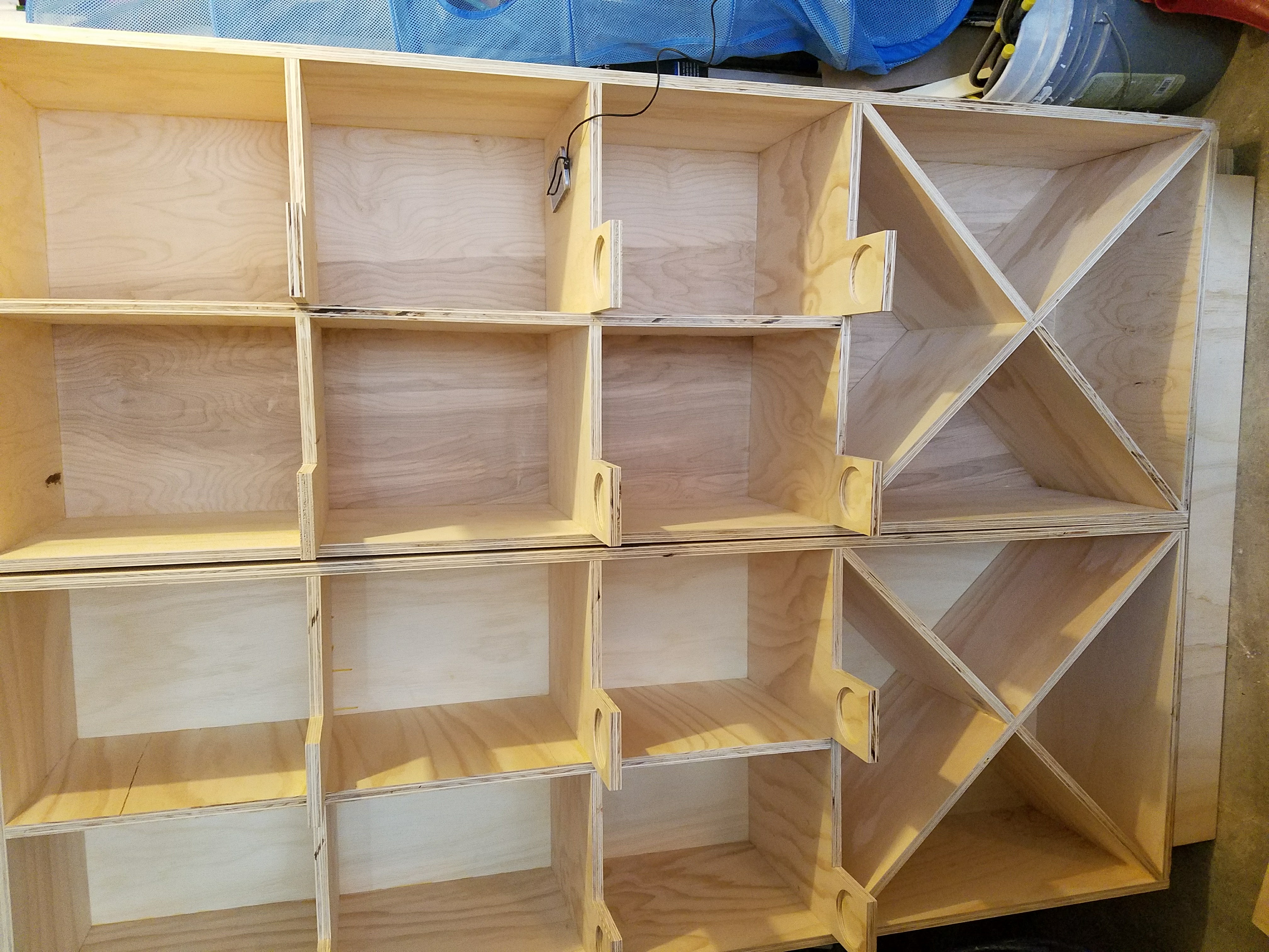 Custom plywood cabinet unit under construction with X-shaped divider sections by Rome Leite Home Improvement in Danbury, CT