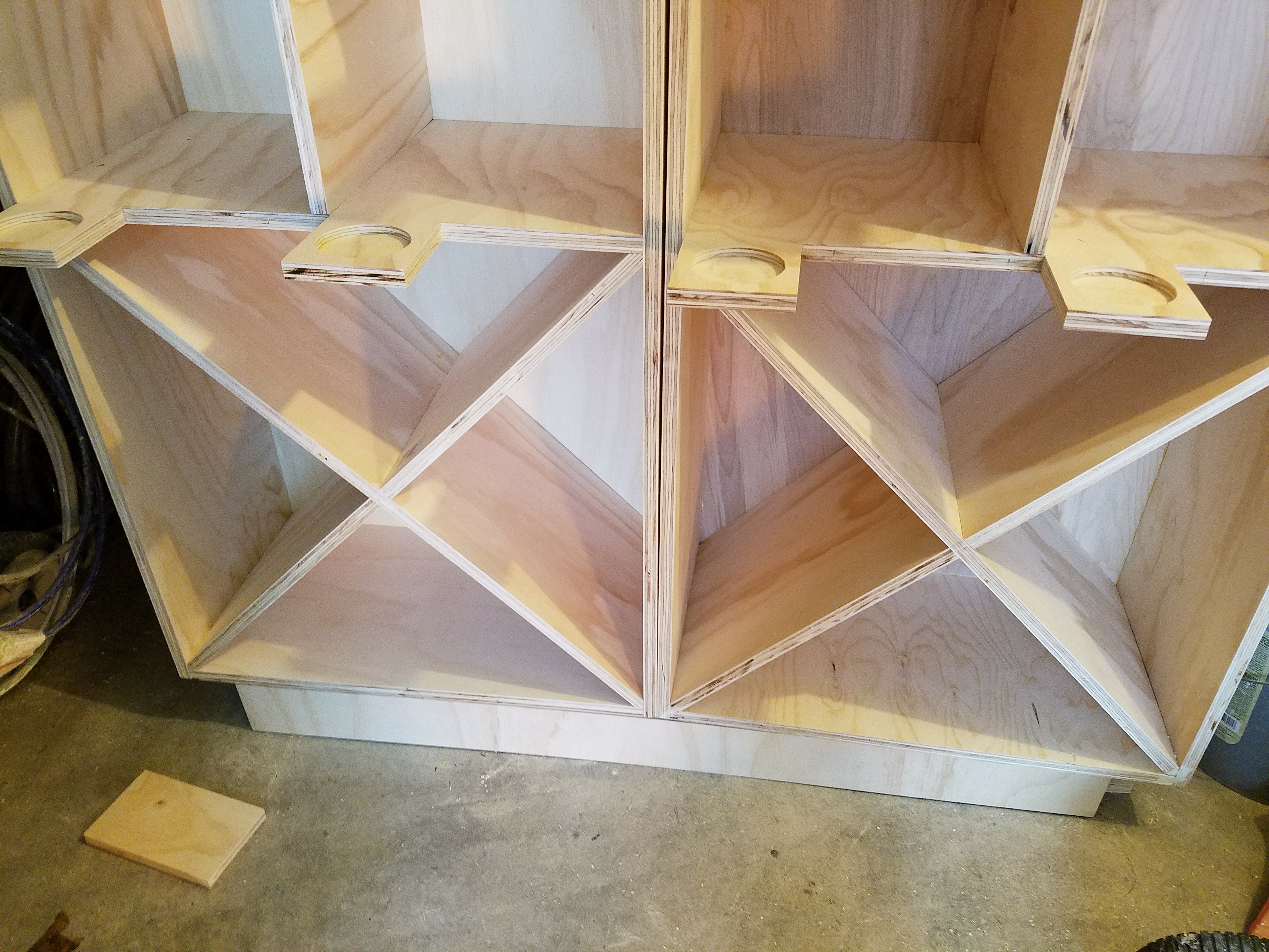 Close-up of X-shaped plywood dividers in a custom cabinet build by Rome Leite Home Improvement in Danbury, CT