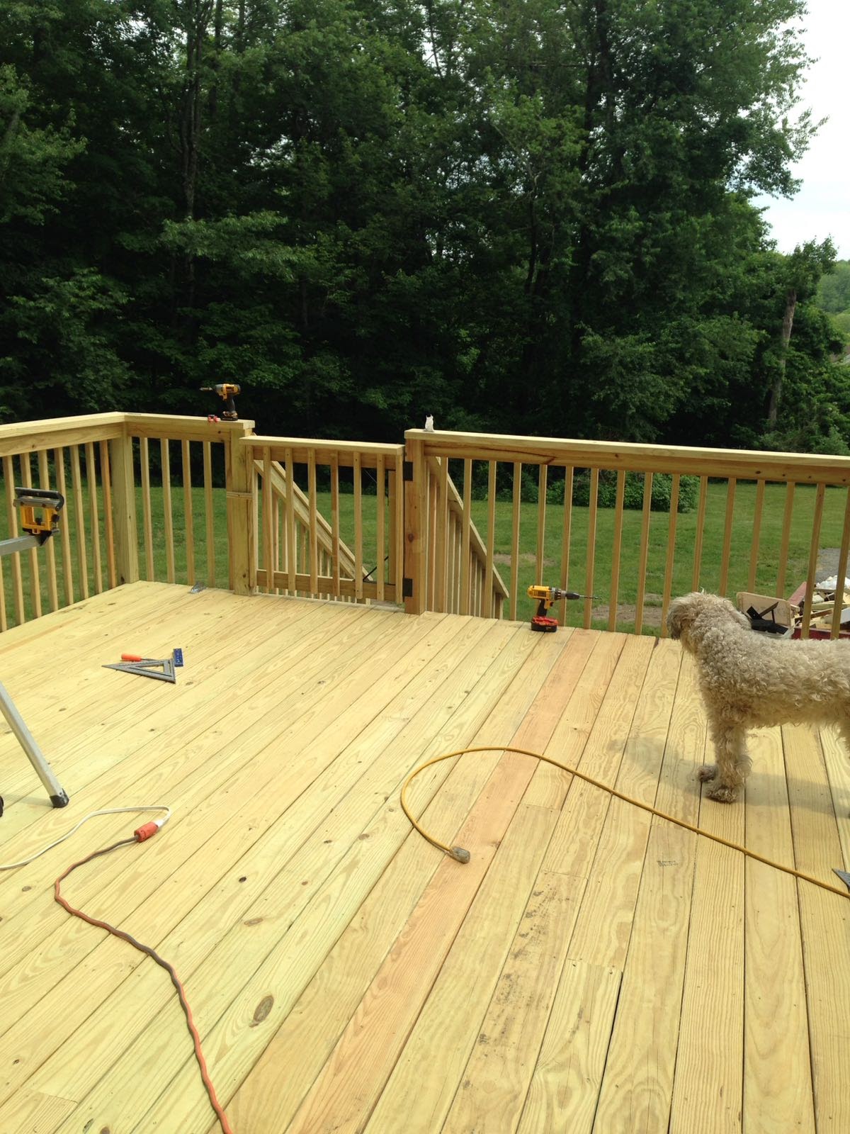 Two-level wood deck under construction with connecting stairs by Rome Leite Home Improvement in Danbury, CT