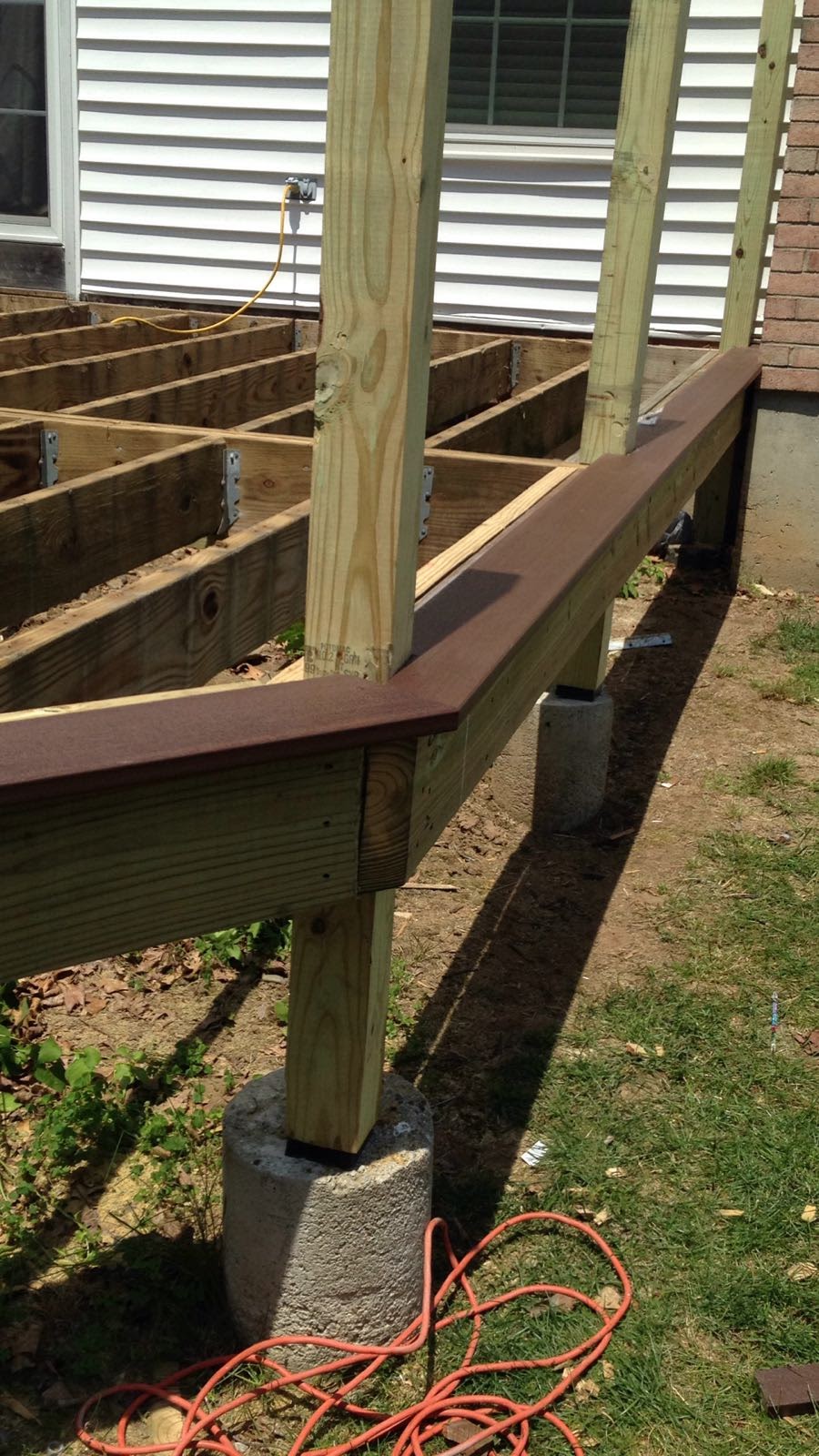 Deck edge with composite decking installed over wood framing on concrete piers by Rome Leite Home Improvement in Danbury, CT