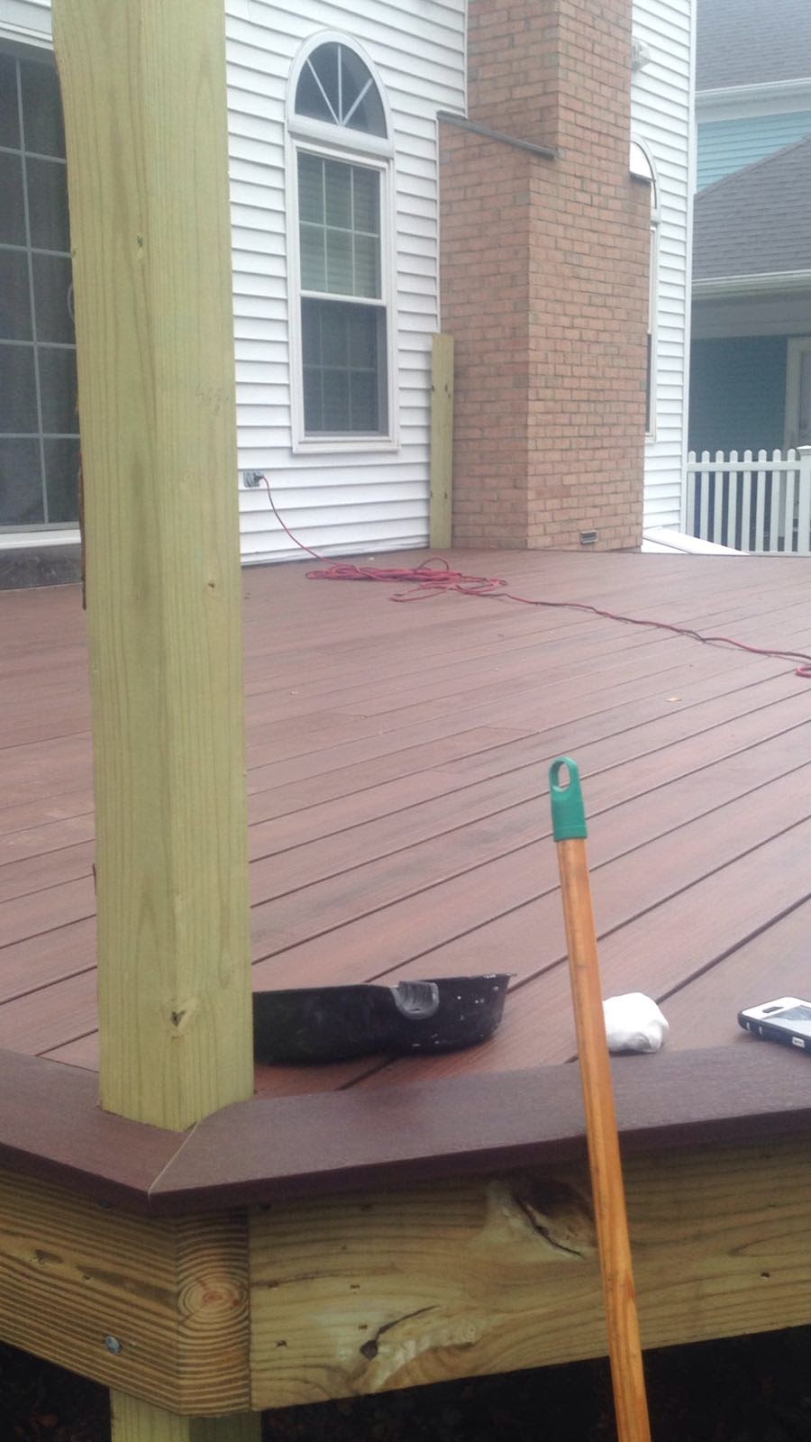 Finished deck with composite decking boards and a wood support post by Rome Leite Home Improvement in Danbury, CT