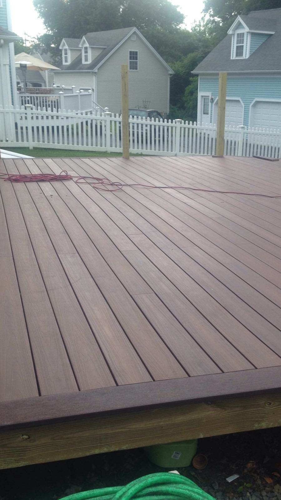 White vinyl deck railing section installed against a house by Rome Leite Home Improvement in Danbury, CT