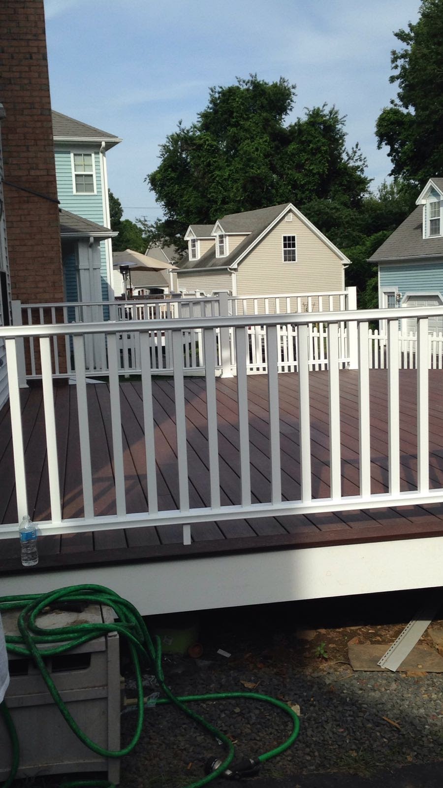 Close-up of a white vinyl deck railing post over dark composite decking by Rome Leite Home Improvement in Danbury, CT