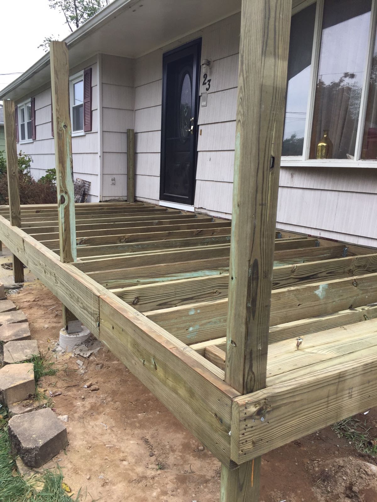 Front porch deck framing under construction with support posts by Rome Leite Home Improvement in Danbury, CT