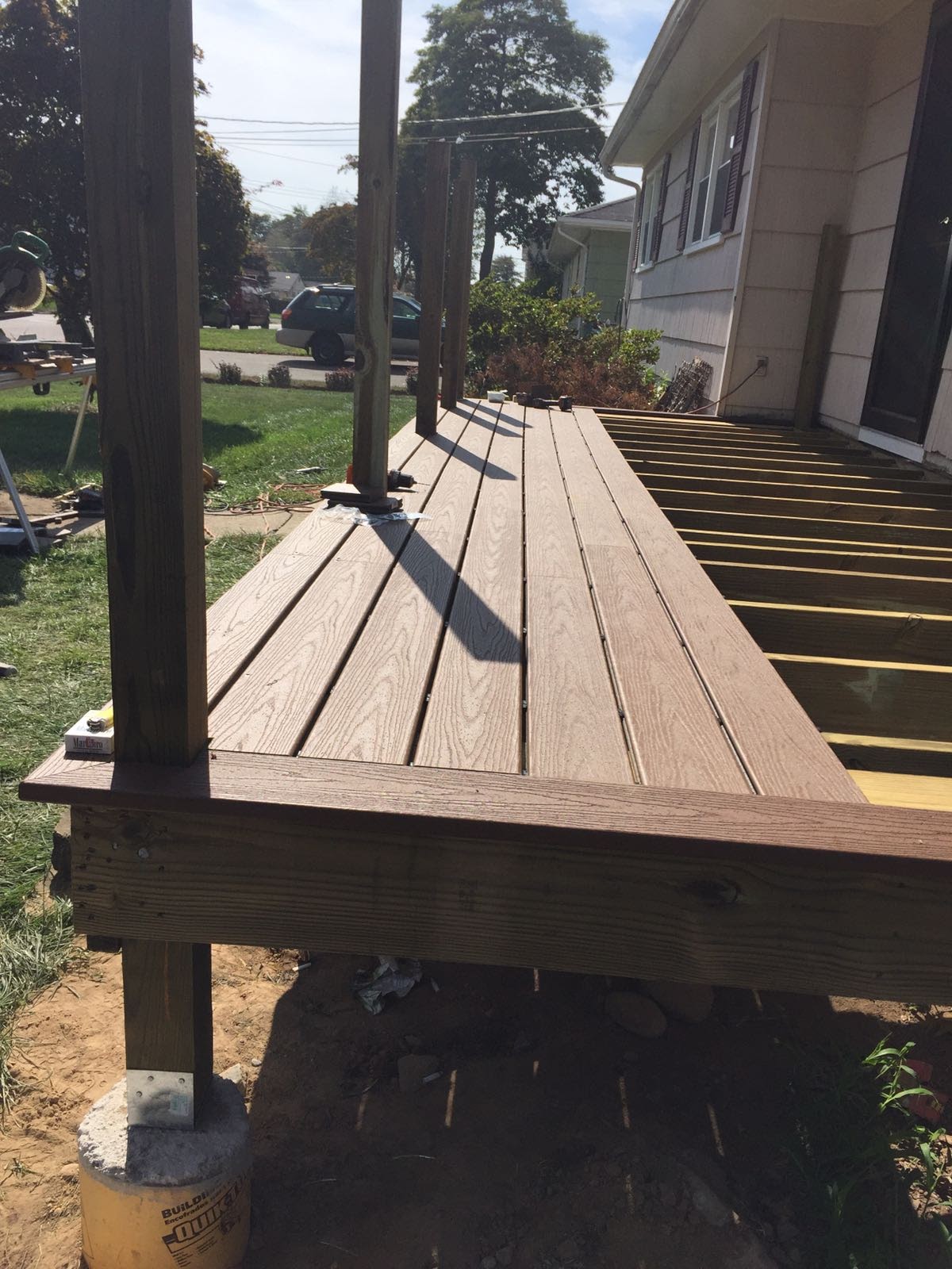 Finished front porch composite deck with a support post by Rome Leite Home Improvement in Danbury, CT