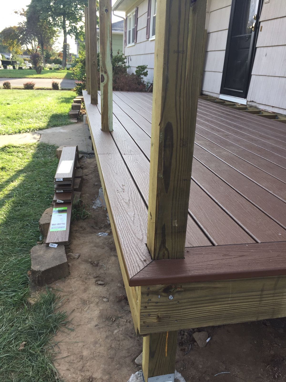Deck under construction showing finished composite corner trim and pressure-treated posts by Rome Leite Home Improvement in Danbury, CT