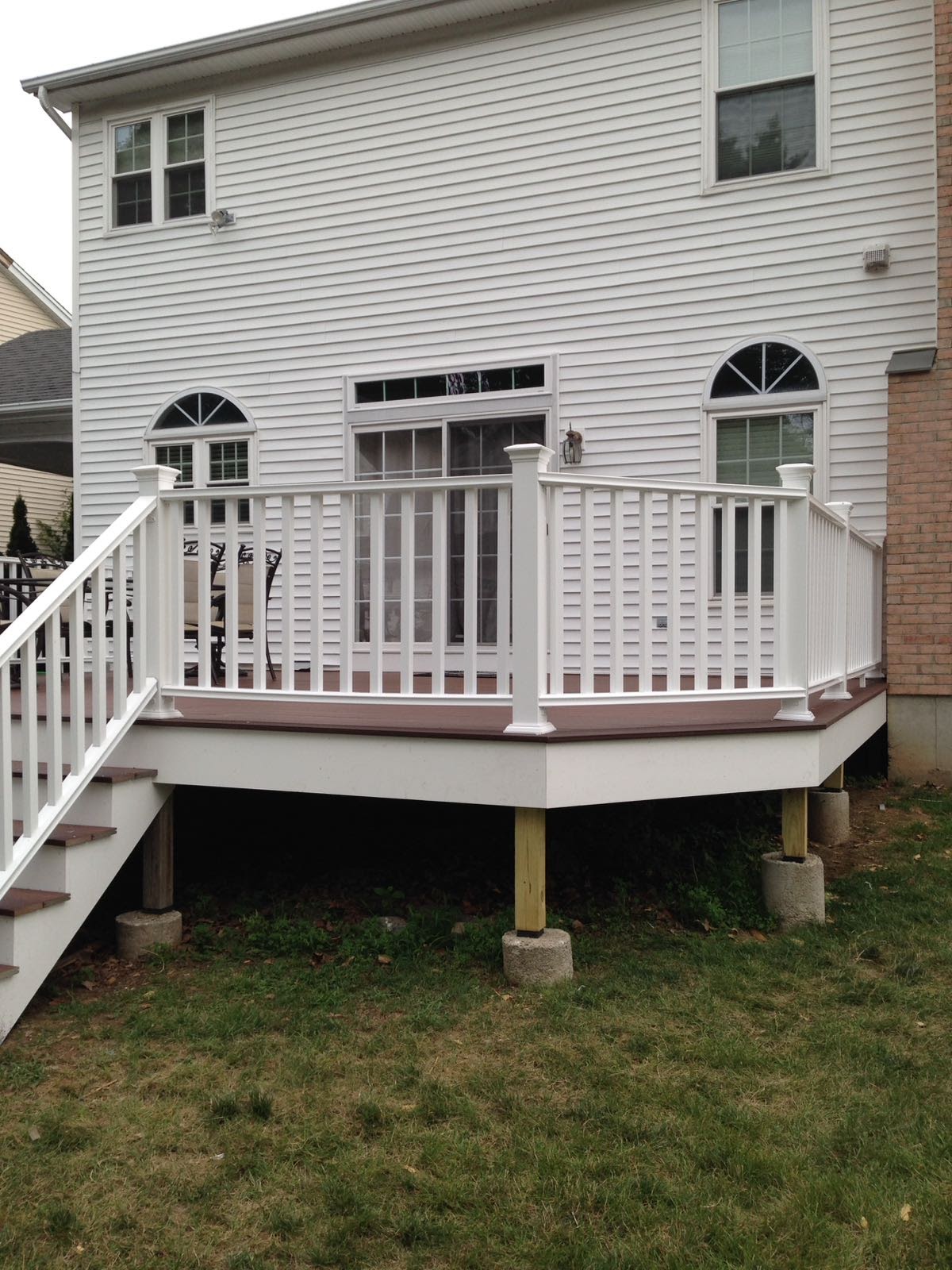 Front concrete porch step demolition with rubble and exposed rotted wood trim by Rome Leite Home Improvement in Danbury, CT