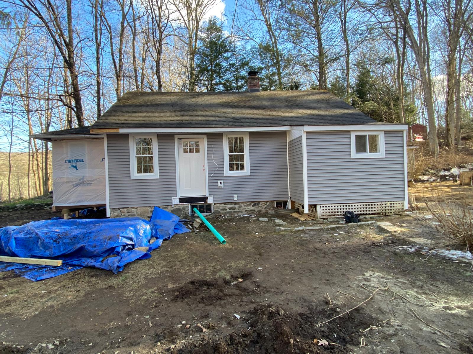Front exterior of a house with finished siding, windows, and a dormer by Rome Leite Home Improvement in Danbury, CT