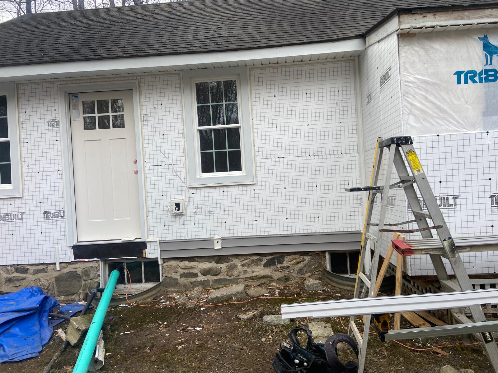 Newly installed exterior door and window with house wrap by Rome Leite Home Improvement in Danbury, CT