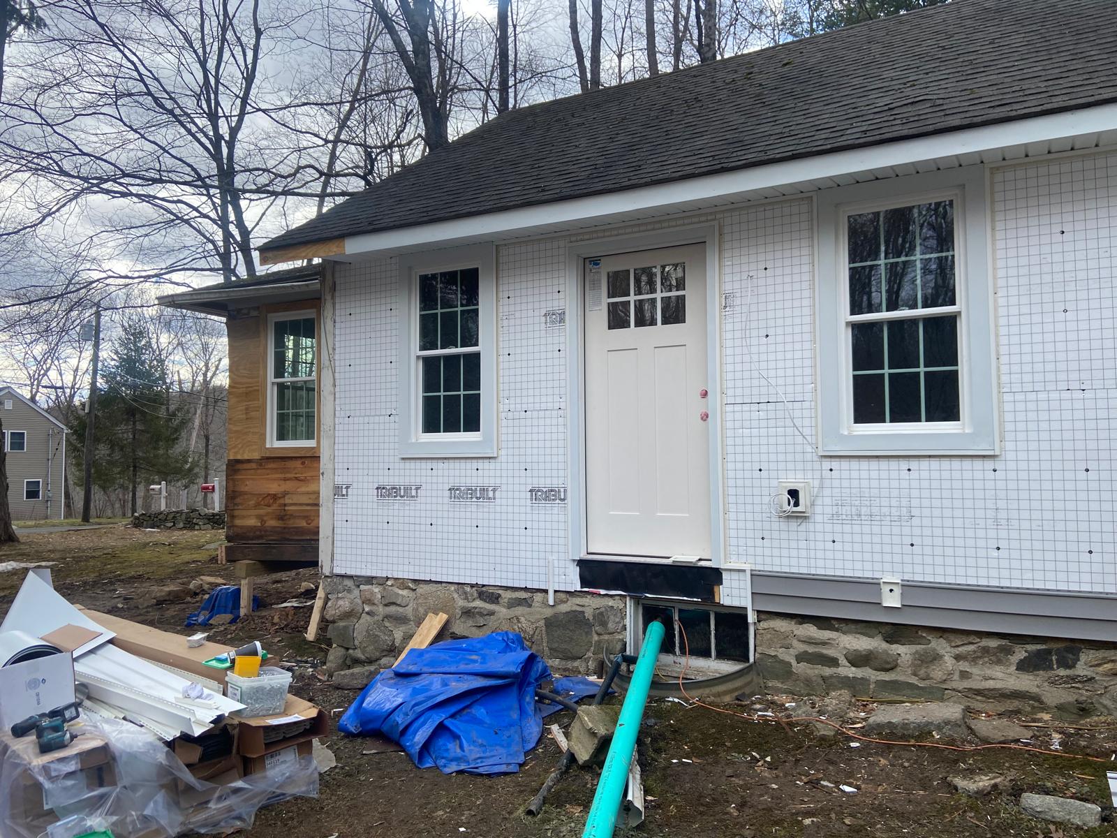 Exterior of a house addition with a framed, partially sheathed gable by Rome Leite Home Improvement in Danbury, CT