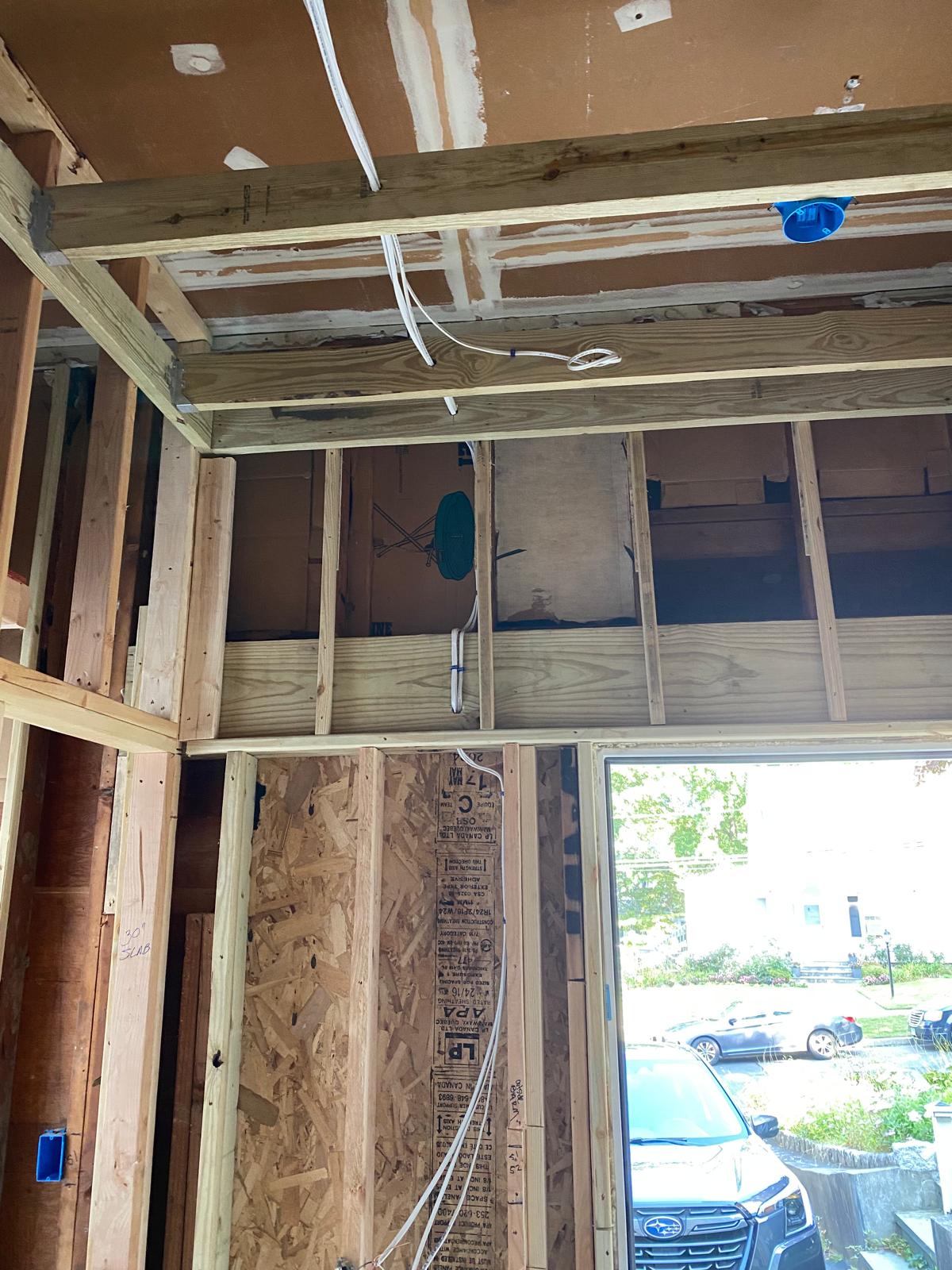 Framed room addition with exposed studs, sheathing, and electrical wiring by Rome Leite Home Improvement in Danbury, CT