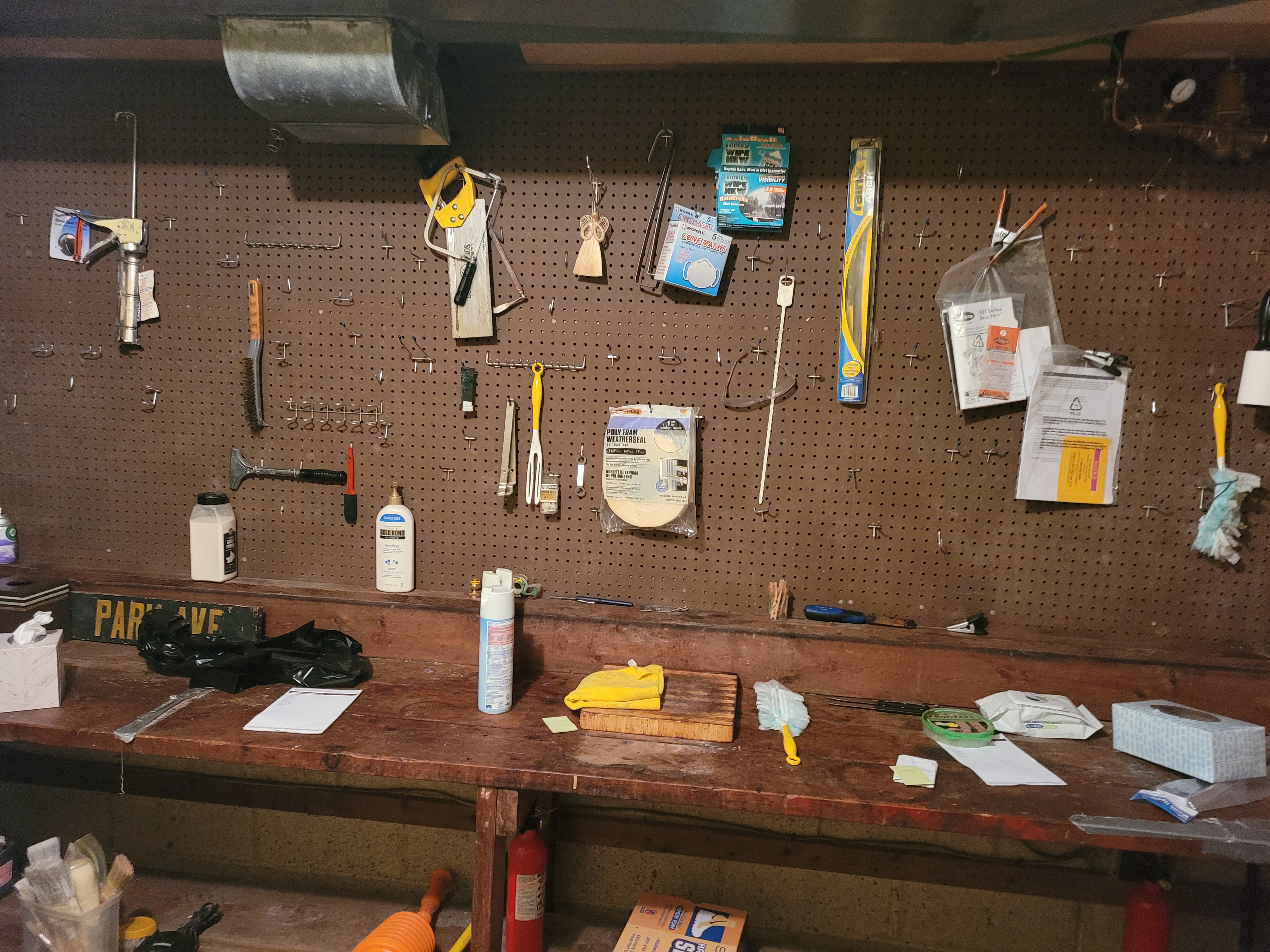 Garage workshop pegboard wall hung with hand tools next to a workbench by Rome Leite Home Improvement in Danbury, CT