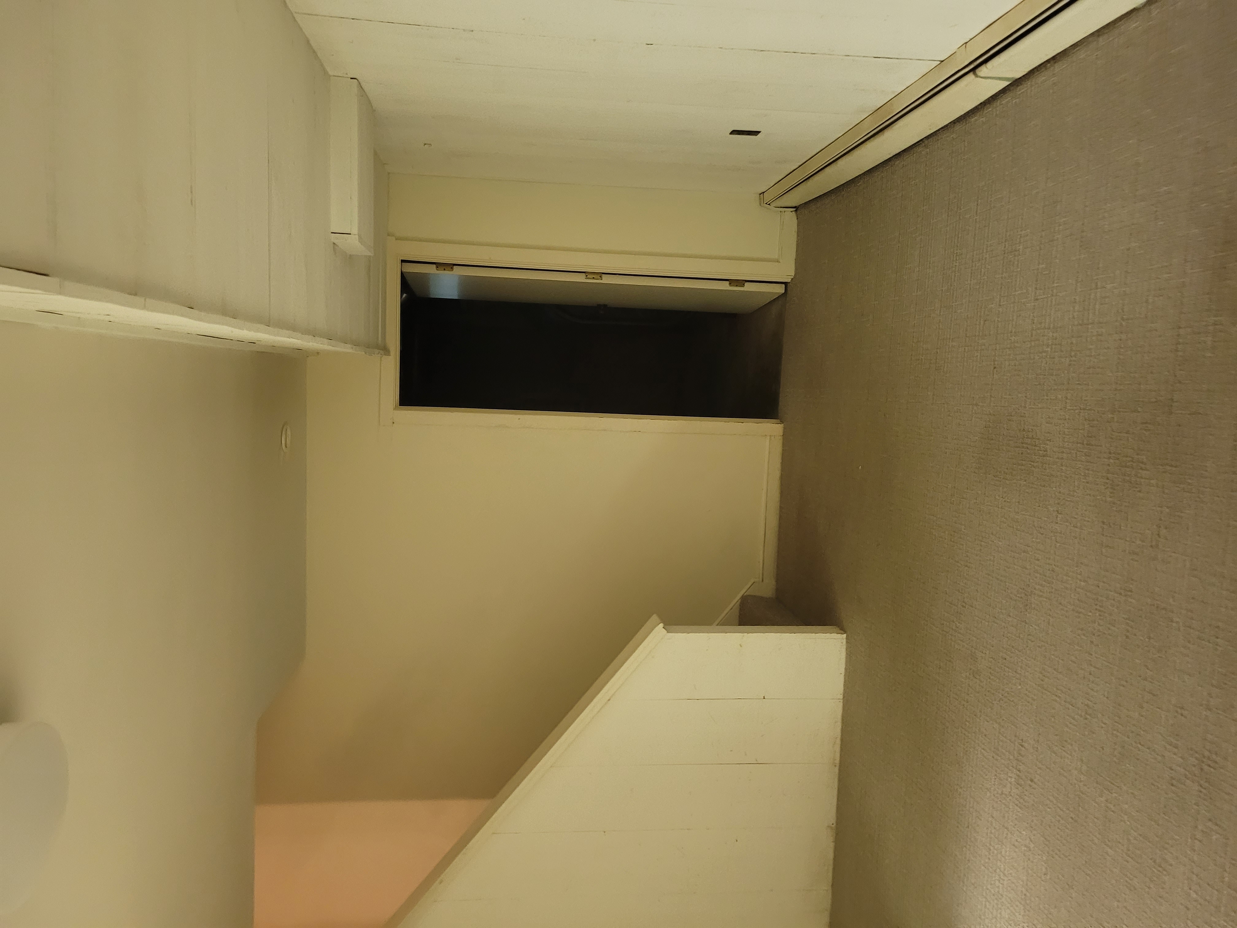 Stairwell area with an open attic or crawlspace access hatch by Rome Leite Home Improvement in Danbury, CT
