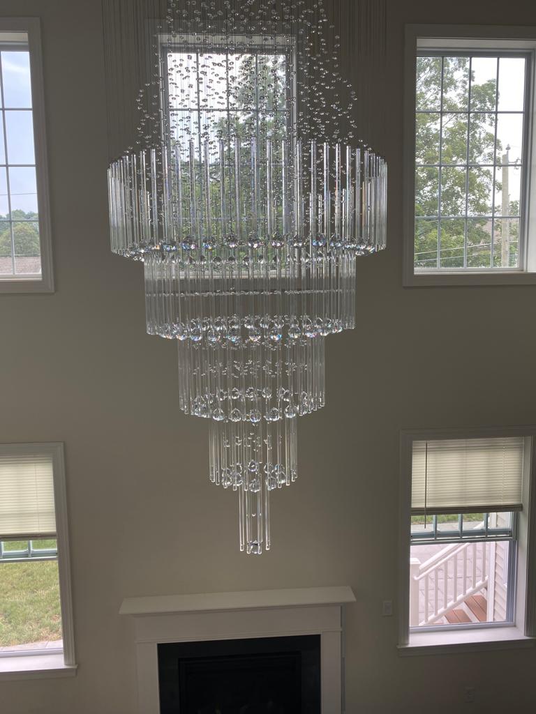 Tiered crystal chandelier installation by Rome Leite Home Improvement