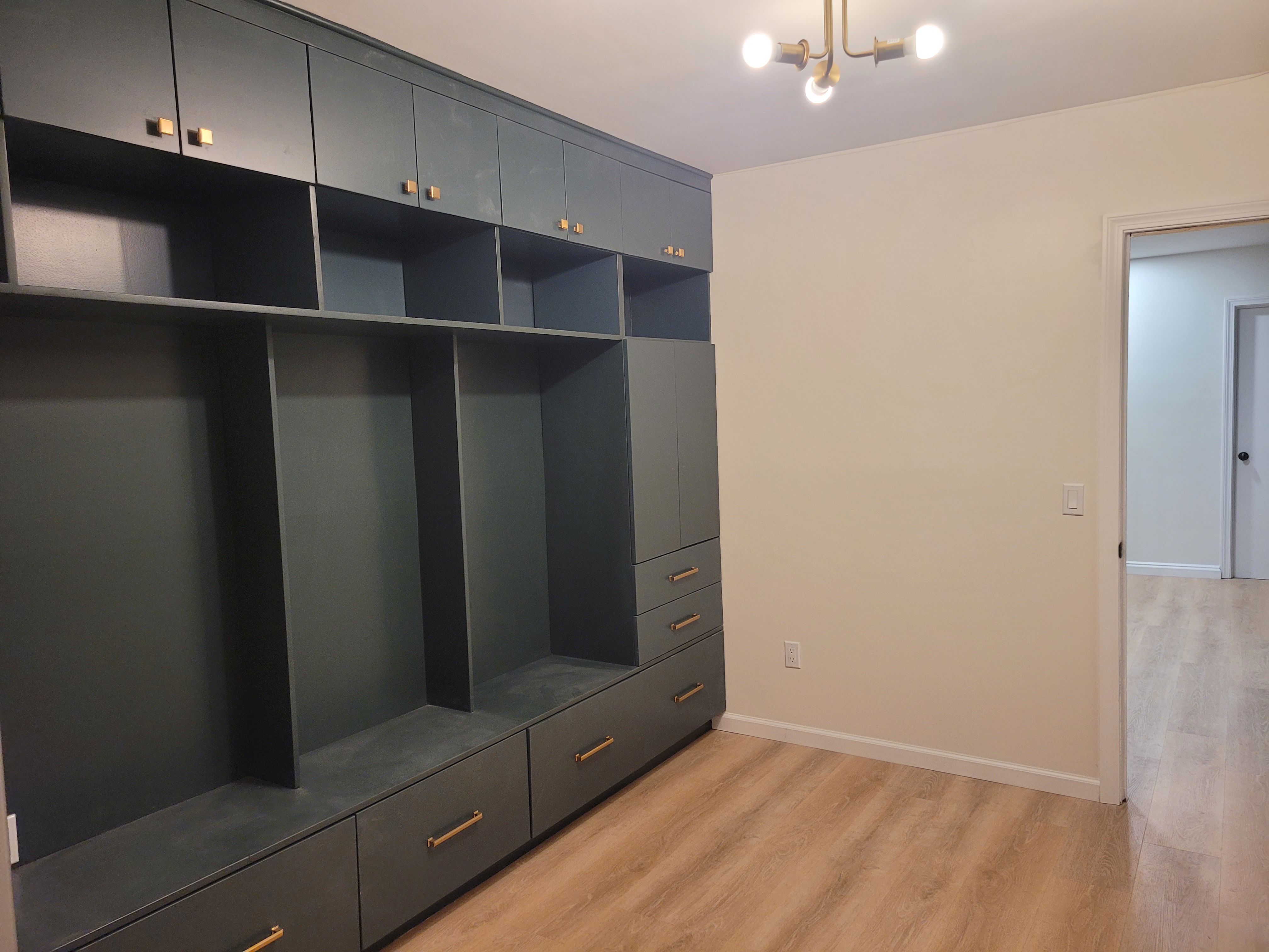 Mudroom built-in lockers viewed from another angle with a pendant light fixture visible by Rome Leite Home Improvement in Danbury, CT