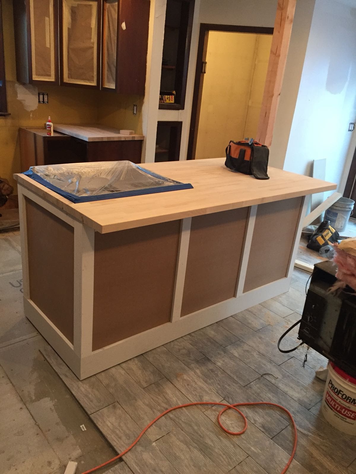 In-progress kitchen island with unfinished panel sides and a butcher-block countertop by Rome Leite Home Improvement in Danbury, CT